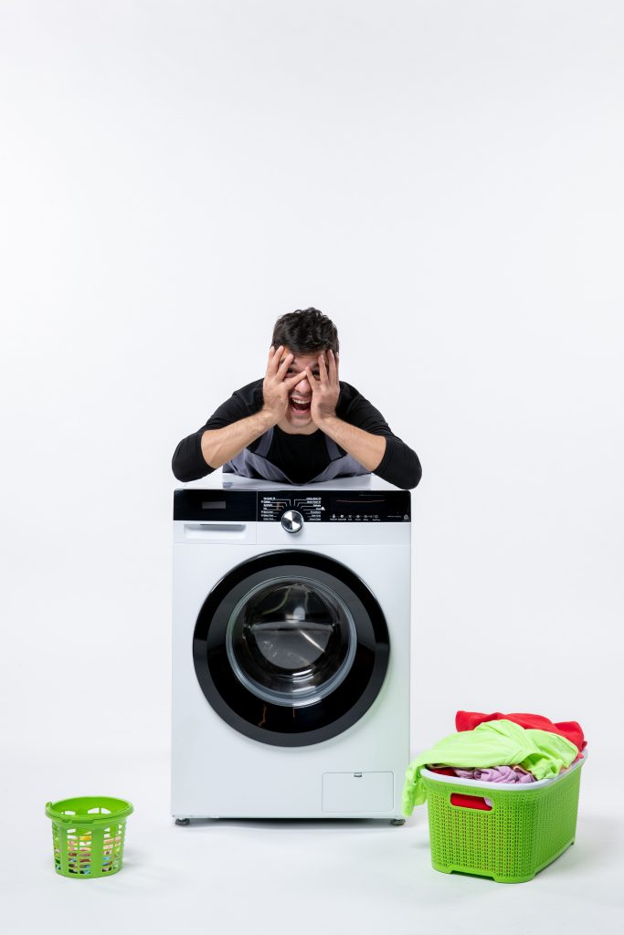 front-view-young-male-with-washer-dirty-clothes-white-wall (2)