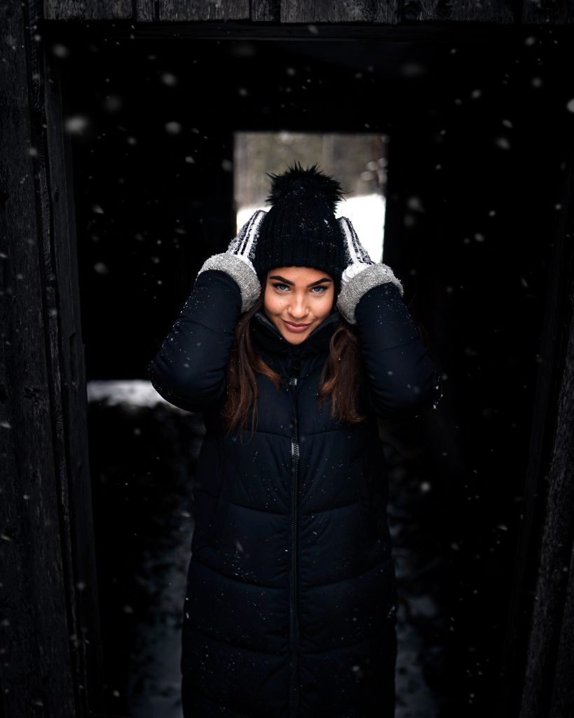 vertical-shot-attractive-female-fixing-her-knit-cap