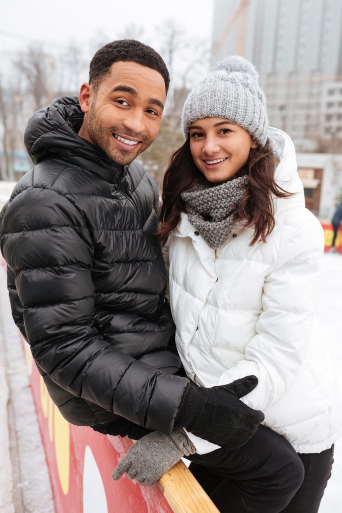 young-smiling-loving-couple-skating-ice-rink-outdoors